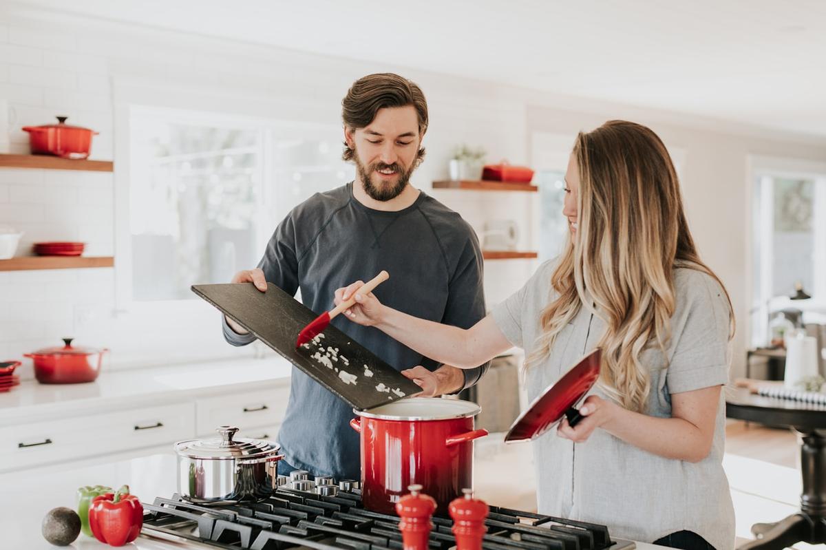 Family cooking together in a modern kitchen with stainless steel appliances
